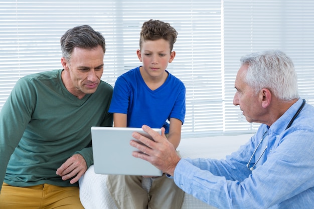 Doctor and patient discussing over digital tablet