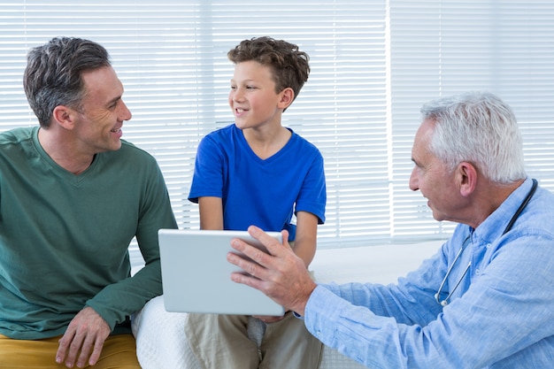 Doctor and patient discussing over digital tablet