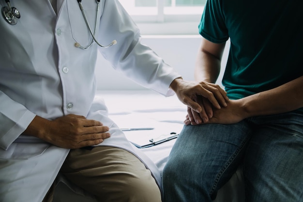 Doctor and patient discussing something while sitting at the table Medicine and health care concept Doctor and patient