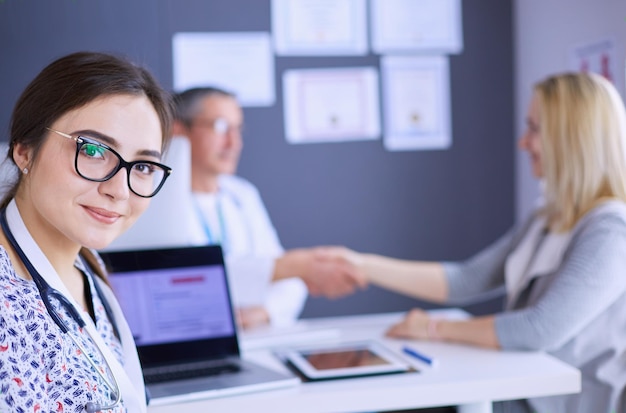 Doctor and patient discussing something while sitting at the table Medicine and health care concept