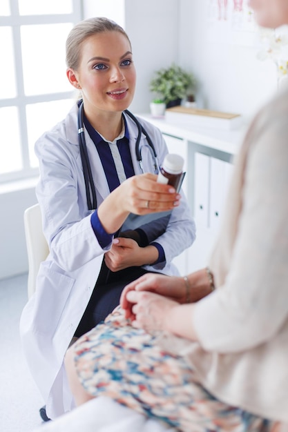 doctor and patient discussing something while sitting at the table medicine and health care concept