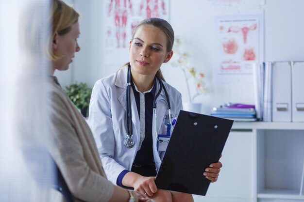 Doctor and patient discussing something while sitting at the table Medicine and health care concept