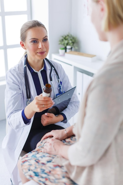 Doctor and patient discussing something while sitting at the table Medicine and health care concept