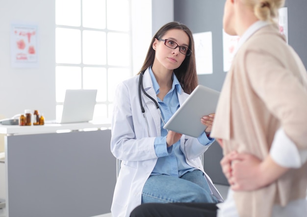 Doctor and patient discussing something while sitting at the table Medicine and health care concept