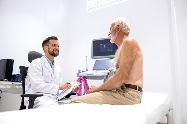 Doctor and patient having a conversation before ultrasound examination