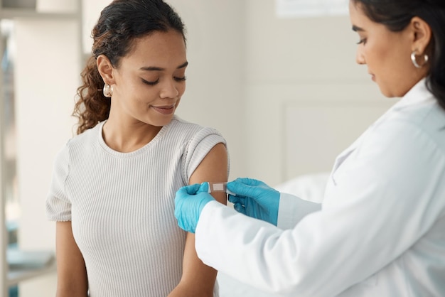 Photo doctor patient and plaster for vaccination at a clinic for health and wellness for virus healthcare vaccine and patch at the hospital with cure for safety with medical results with medicine