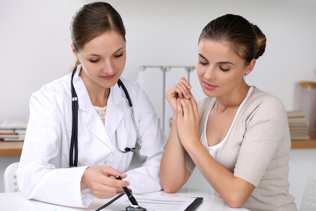 Doctor and patient sitting at the desk Medicine and health care concept