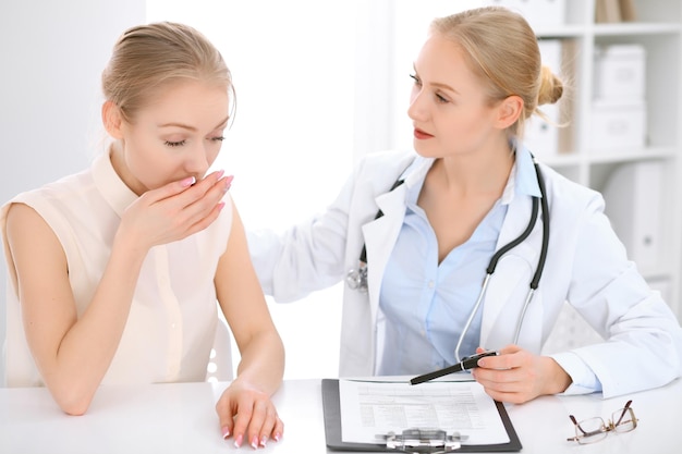 Doctor and patient sitting at the desk. Medicine and health care concept