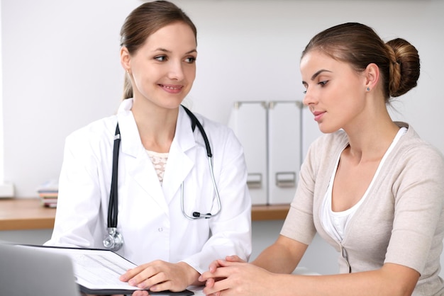 Doctor and patient sitting at the desk Medicine and health care concept