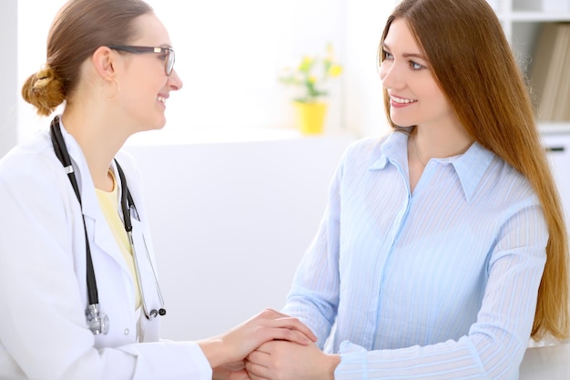 Doctor and patient sitting at the desk near window