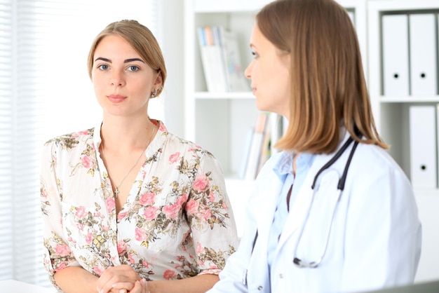 Doctor and  patient  sitting at the desk