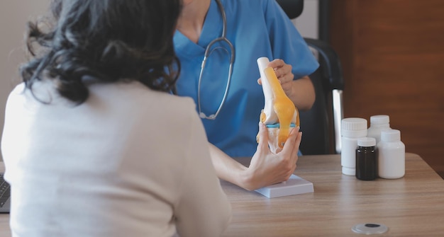 Doctor and patient talking while sitting at the desk in hospital office closeup of human hands Medicine and health care concept