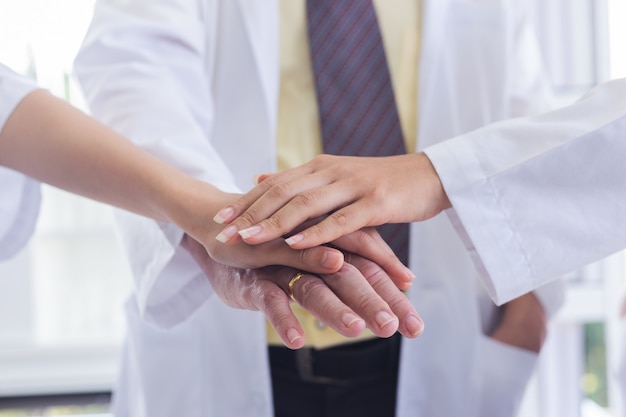 Doctor people joining hands together and teamwork concept.