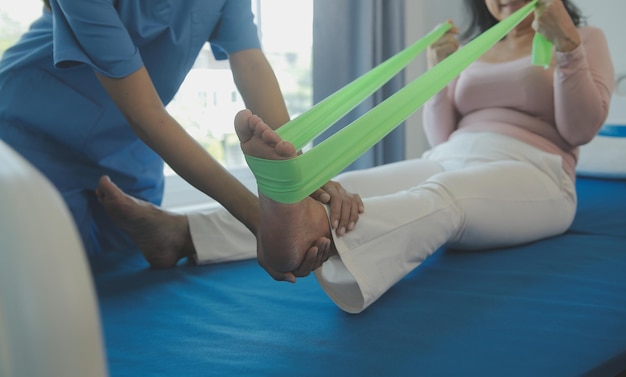 Doctor or physical therapist examines back pain and spinal area to give advice within the rehabilitation center