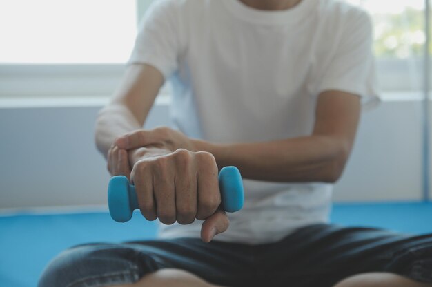 Doctor or physical therapist examines back pain and spinal area to give advice within the rehabilitation center