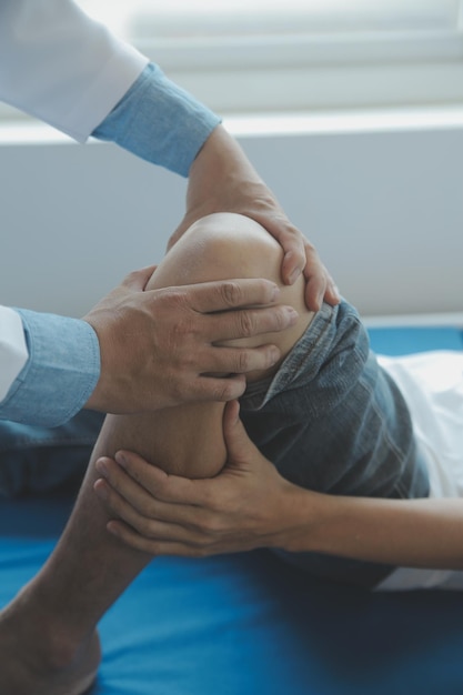 Doctor or physical therapist examines back pain and spinal area to give advice within the rehabilitation center