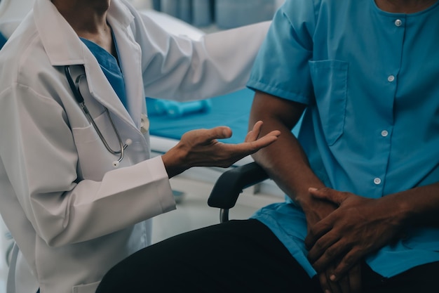 Photo doctor or physiotherapist working examining treating injured arm of athlete male patient stretching and exercise doing the rehabilitation therapy pain in clinic