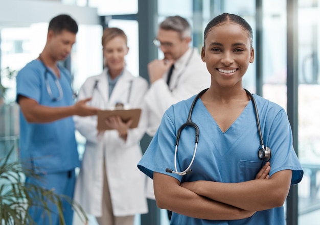 Doctor portrait or black woman nurse with vision motivation or leadership in hospital with team Happy medical healthcare wellness worker with smile at work for insurance or medicine in clinic