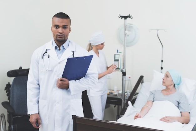 Doctor posing against the background of the patient 