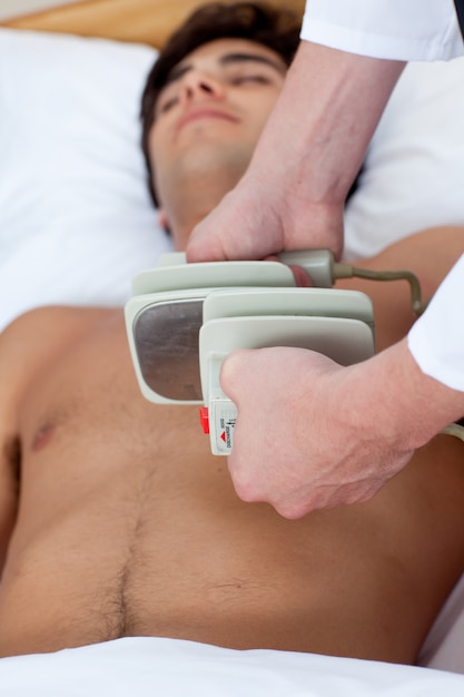 A doctor preparing a defibrillation