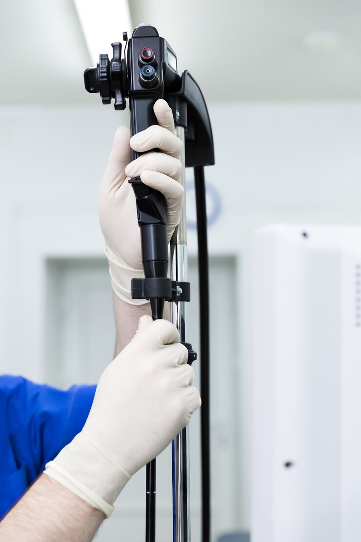 Doctor preparing endoscope on tripod