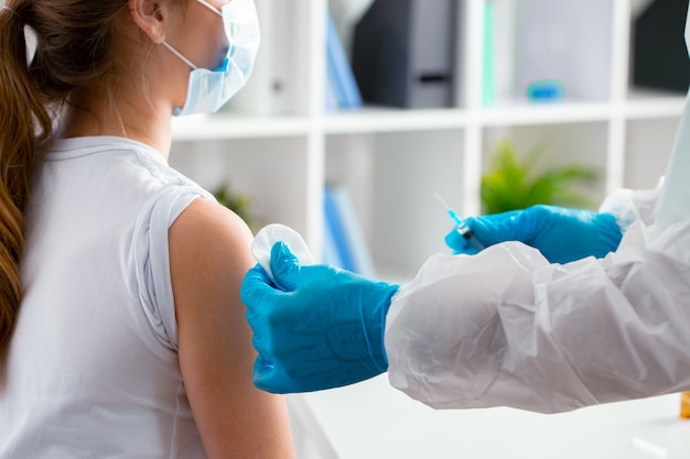 Doctor preparing for vaccination of patient in hospital close up