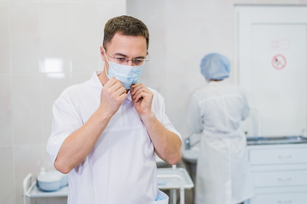 Doctor preparing with protective accessories