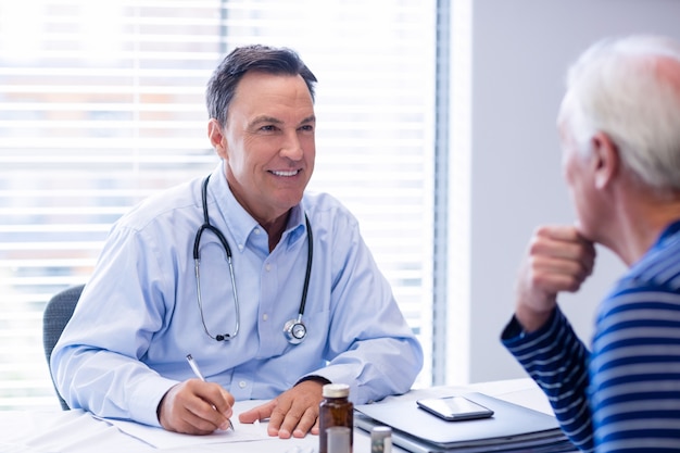 Doctor prescribing medicine to senior patient