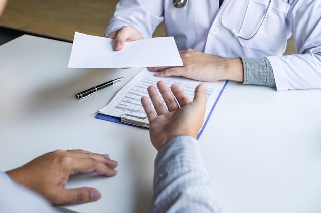 Photo doctor presenting with patient and checking results on report and prescription about the problem of illness and recommend using medicine, healthcare and medical concept.