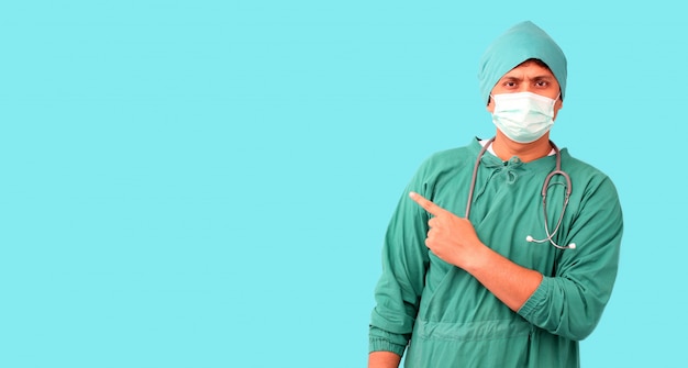 Doctor in protective equipment over blue wall