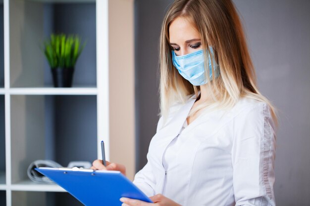 Doctor in protective mask working at the hospital.