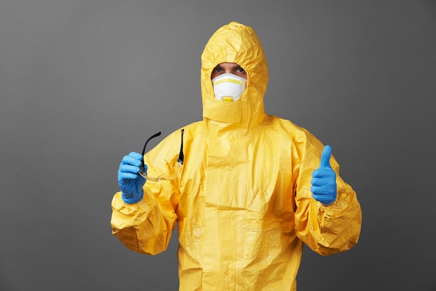 Doctor in a protective suit with medical mask and protective gloves