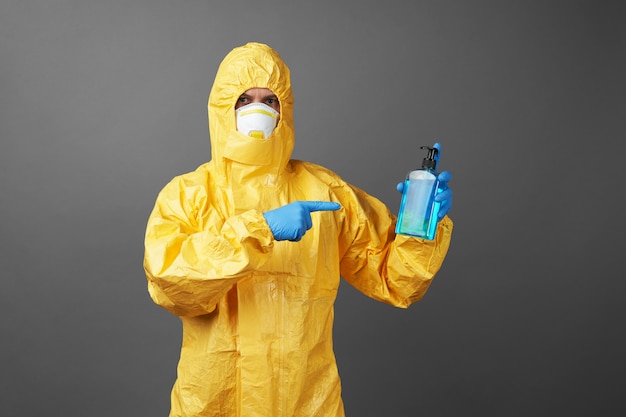 Doctor in a protective suit with medical mask and protective gloves