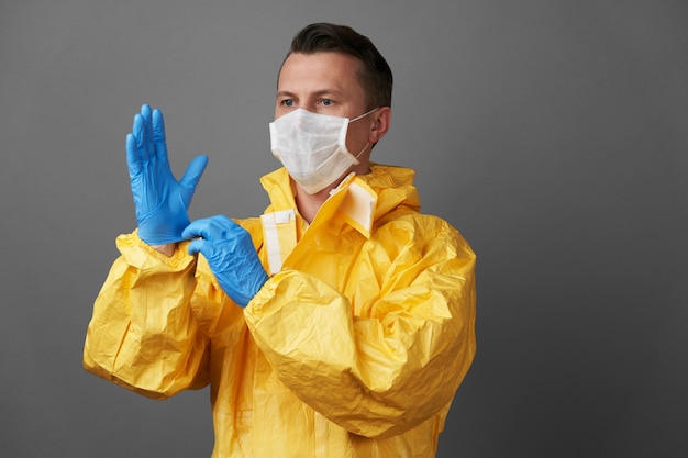 Doctor in a protective suit with medical mask and protective gloves