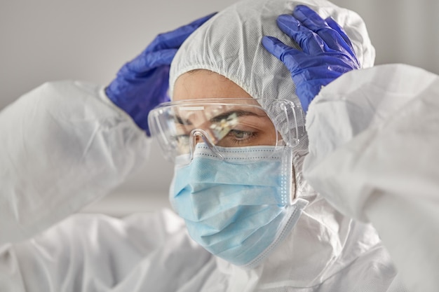 doctor in protective wear medical mask and gloves