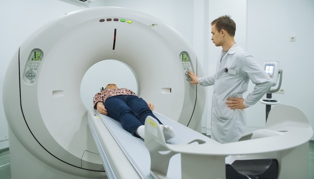 Doctor pushing buttons on mri tomograph