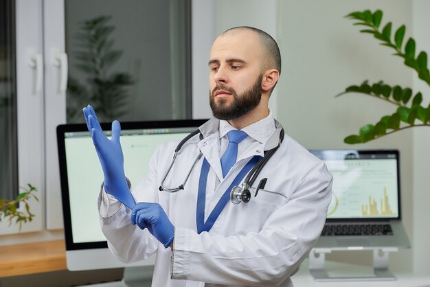 A doctor putting on a disposable medical glove