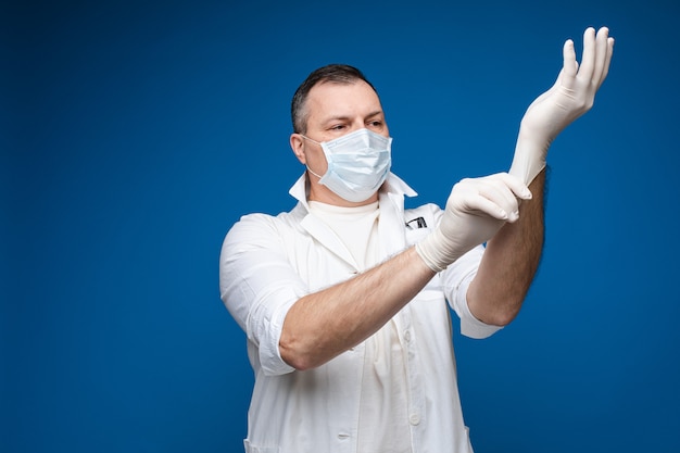 Doctor putting on white gloves