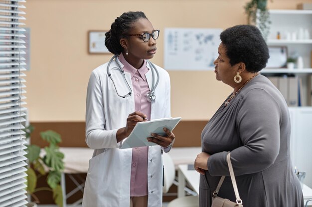 Doctor questioning patient in clinic