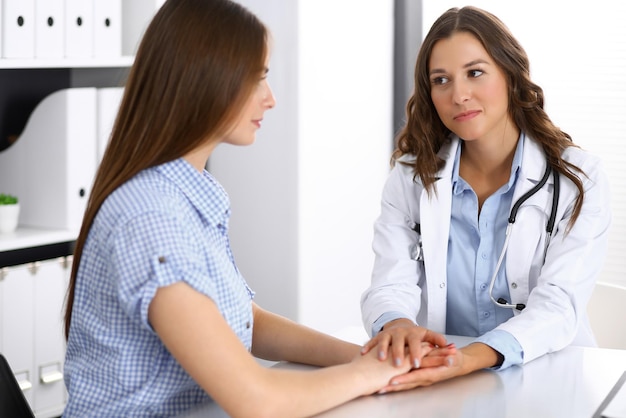 Doctor reassuring her female patient. Medical ethics and trust concept. Medicine and health care theme.