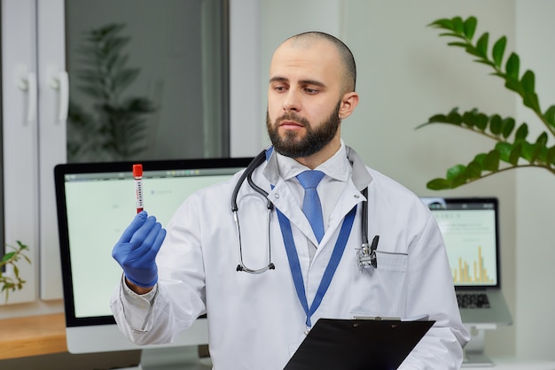 A doctor researching a coronavirus blood tube test in a laboratory.