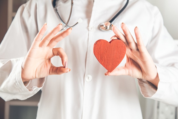 Doctor's hand red heart and okay sign