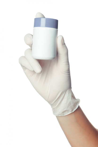 Doctor's hand in white sterilized surgical glove holding medicine