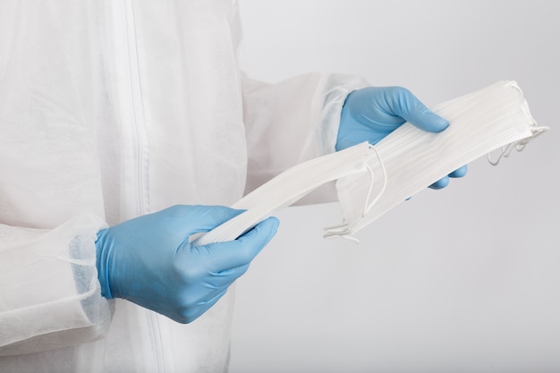 Doctor's hand with some medical face mask for protection against infection