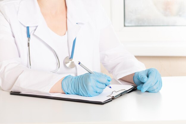 Doctor's handen met een pen in het medische kantoor in de kliniek