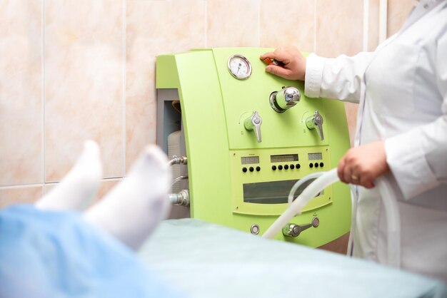 Doctor's hands, a device for cleaning the rectum in the hospital for, the doctor makes a cleaning procedure