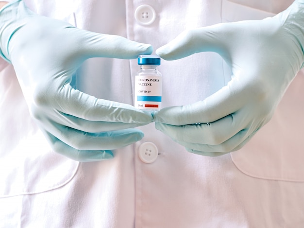 A doctor's hands holding a vial of Coronavirus vaccine. Covid-19