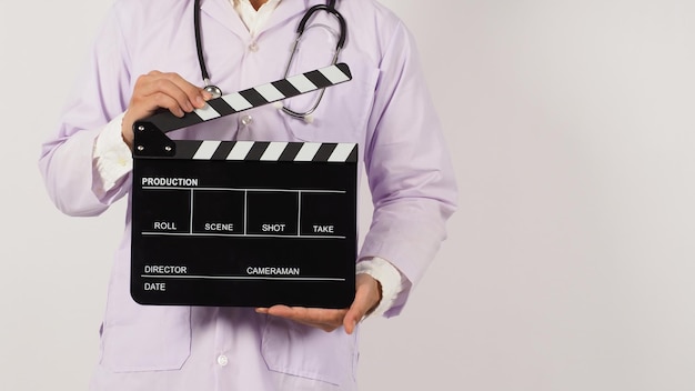 Doctor's holding Black Clapper board in hand on white background Studio shooting