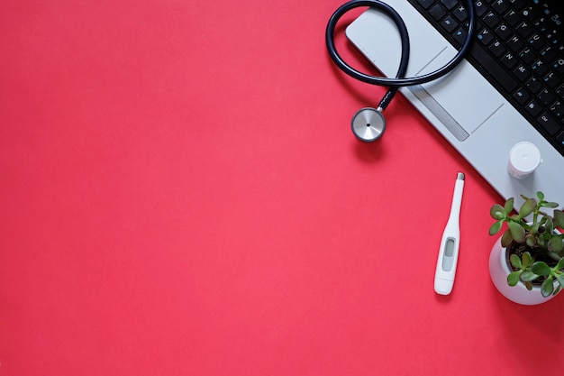 doctor's workplace wit medical equipment on pink