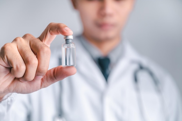 Doctor or scientist carries a syringe and a vaccine against COVID19 vaccination and laboratory experiments Concept of protection against the COVID19 virus